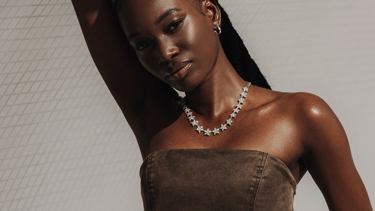 Model in suede strapless top wearing diamond star necklace