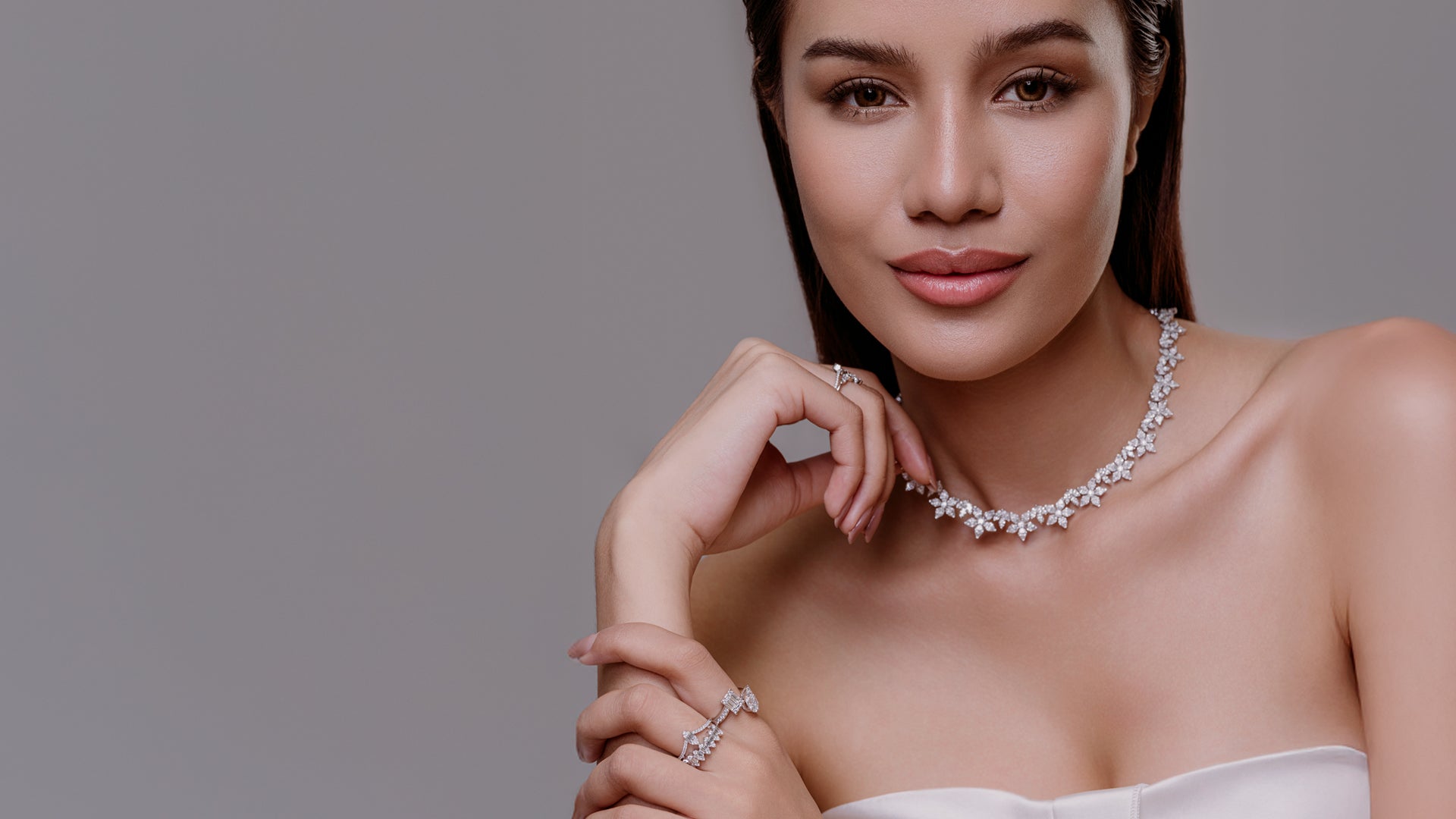 Model in white strapless top with diamond cluster necklace