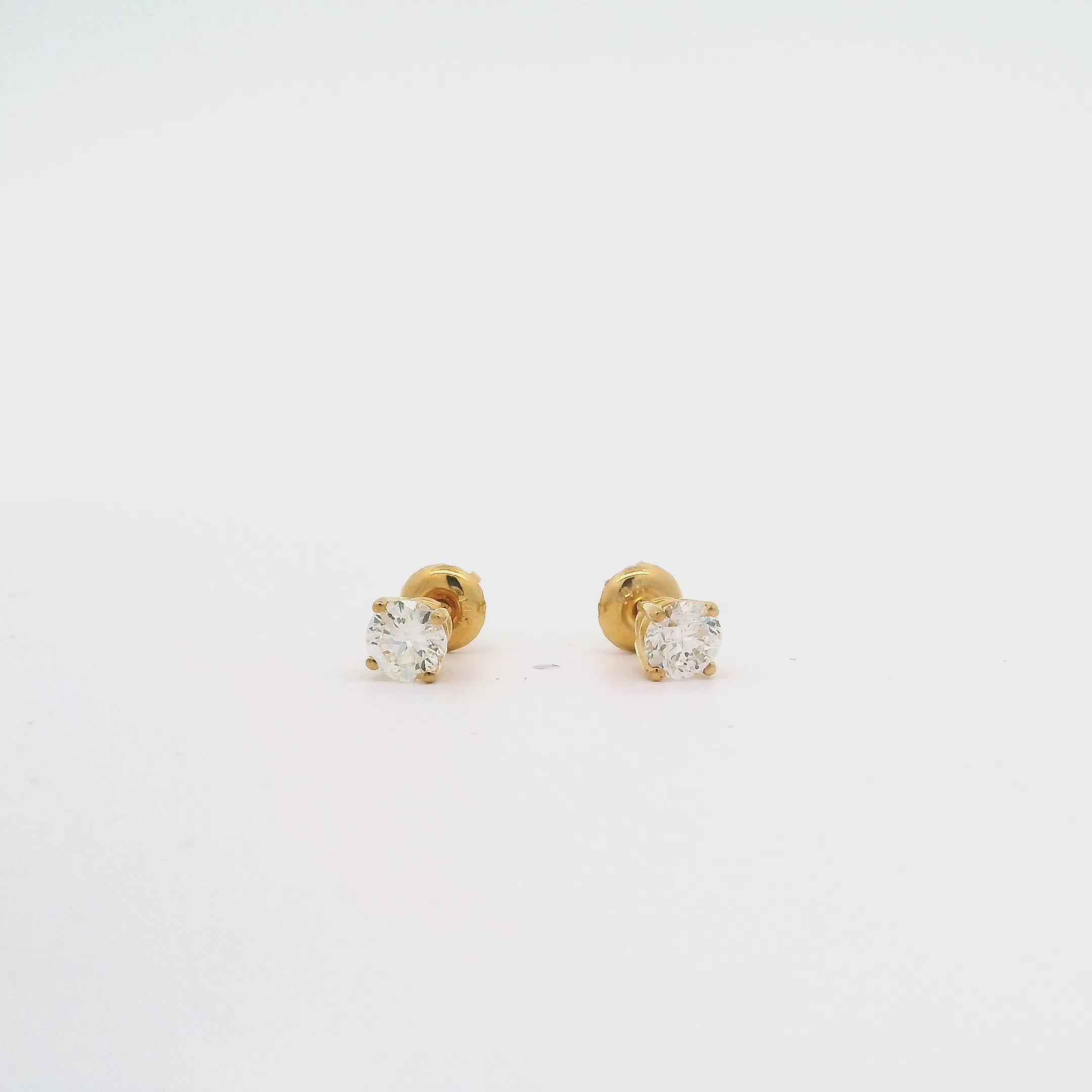 Gold diamond stud earrings with sparkling VS clarity diamonds, set in 14k yellow gold for a touch of timeless glamour and refinement.